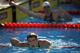 US Michael Phelps reacts after Germany's Paul Biedermann (back) won gold and beat a world record during the men's 200m freestyle final on July 28, 2009 at the FINA World Swimming Championships in Rome. Biedermann clocked 1:42.00 to set a new world record while US Michael Phelps took silver and Russian Danila Izotov got bronze.   AFP PHOTO / CHRISTOPHE SIMON (Photo credit should read CHRISTOPHE SIMON/AFP/Getty Images)